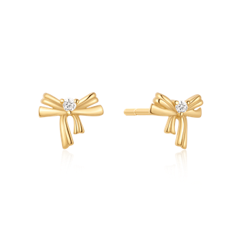 Sølvforgyldte ørestikker fra Støvring Design, sløjfeform med lille sten i midten, gylden farve.